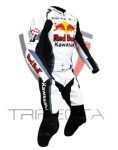 A professional motorcycle racing suit predominantly white with black and blue accents, featuring the Red Bull logo on the chest and shoulders, and the Kawasaki logo on the lower abdomen. The suit has ‘Ninja’ written across the upper back and includes protective patches on the shoulders, elbows, and knees. The attached boots are black with white accents, and the suit has an aerodynamic hump on the upper back