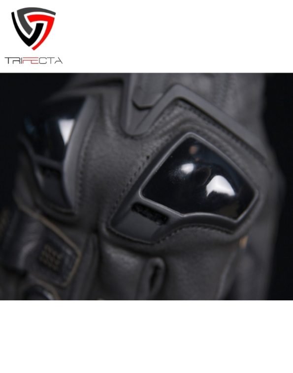 Close-up view of a gray motorcycle glove featuring reinforced knuckle protection with black padding