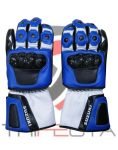 A pair of blue and black motorcycle gloves with white accents and the Suzuki logo on the wrist guard. The gloves feature reinforced knuckle protection and a pre-curved finger design for better grip, displayed against a blurred background with a hint of red.